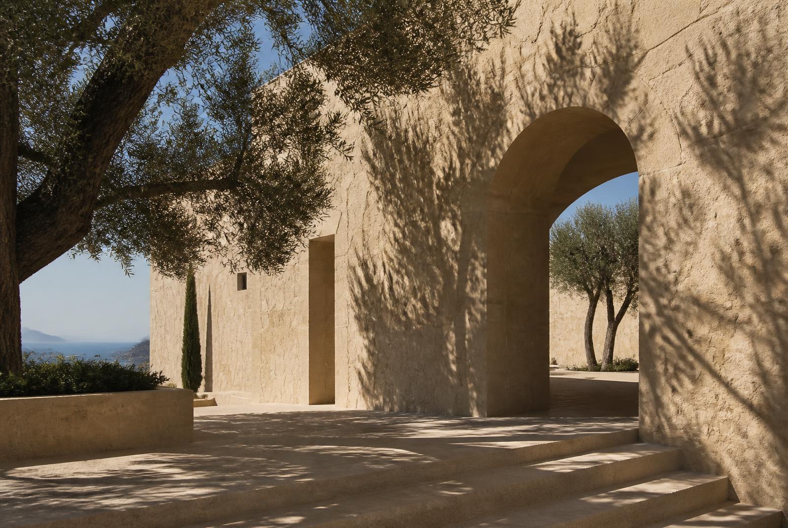 Sandstone villa with an arched opening and olive tree shadows